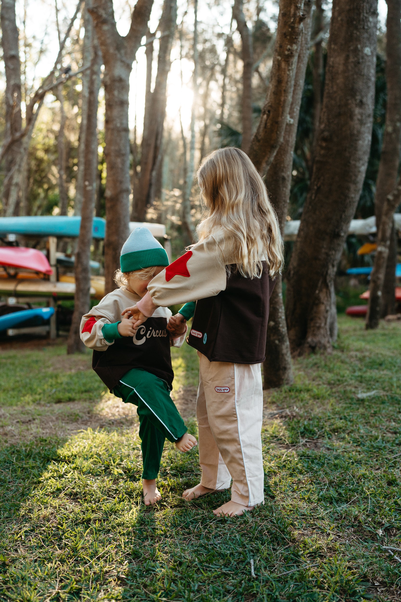 Child in Sonny Label outdoor kayaking lifestyle shot featuring bright kids' clothing.
