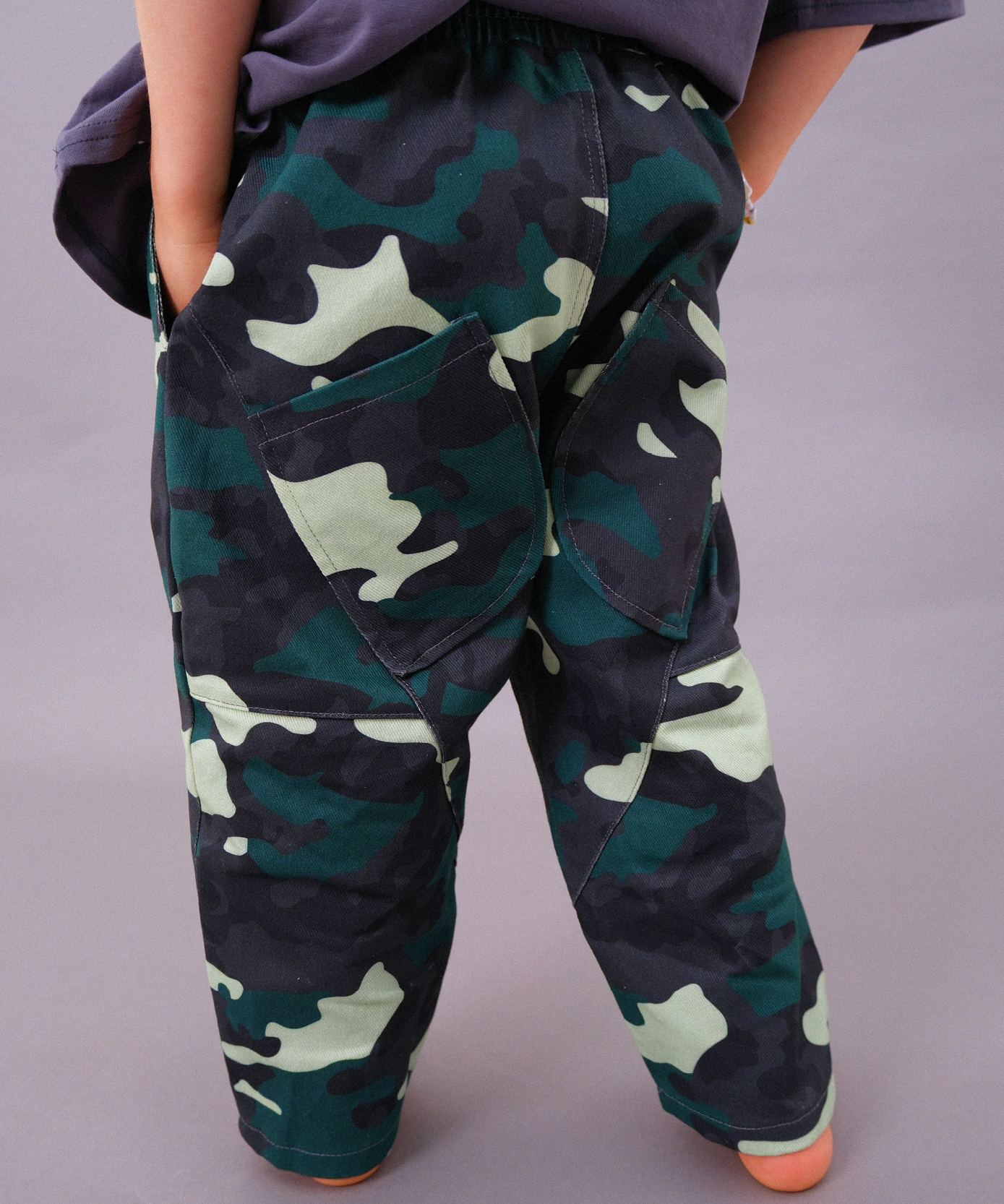 Sonny Label Circus26 camo print piece flat lay on a grey background, second product in the camo range.