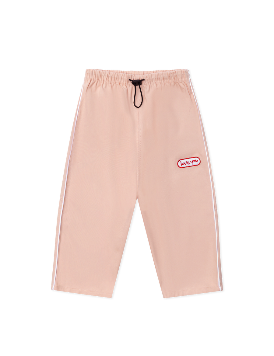 Sonny Label Circus26 floss pink sport pants flat lay on a grey background.
