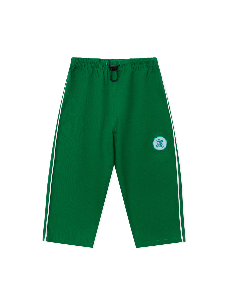 Sonny Label Circus26 forest green sport pants with cream drawstring, flat lay on a grey background.