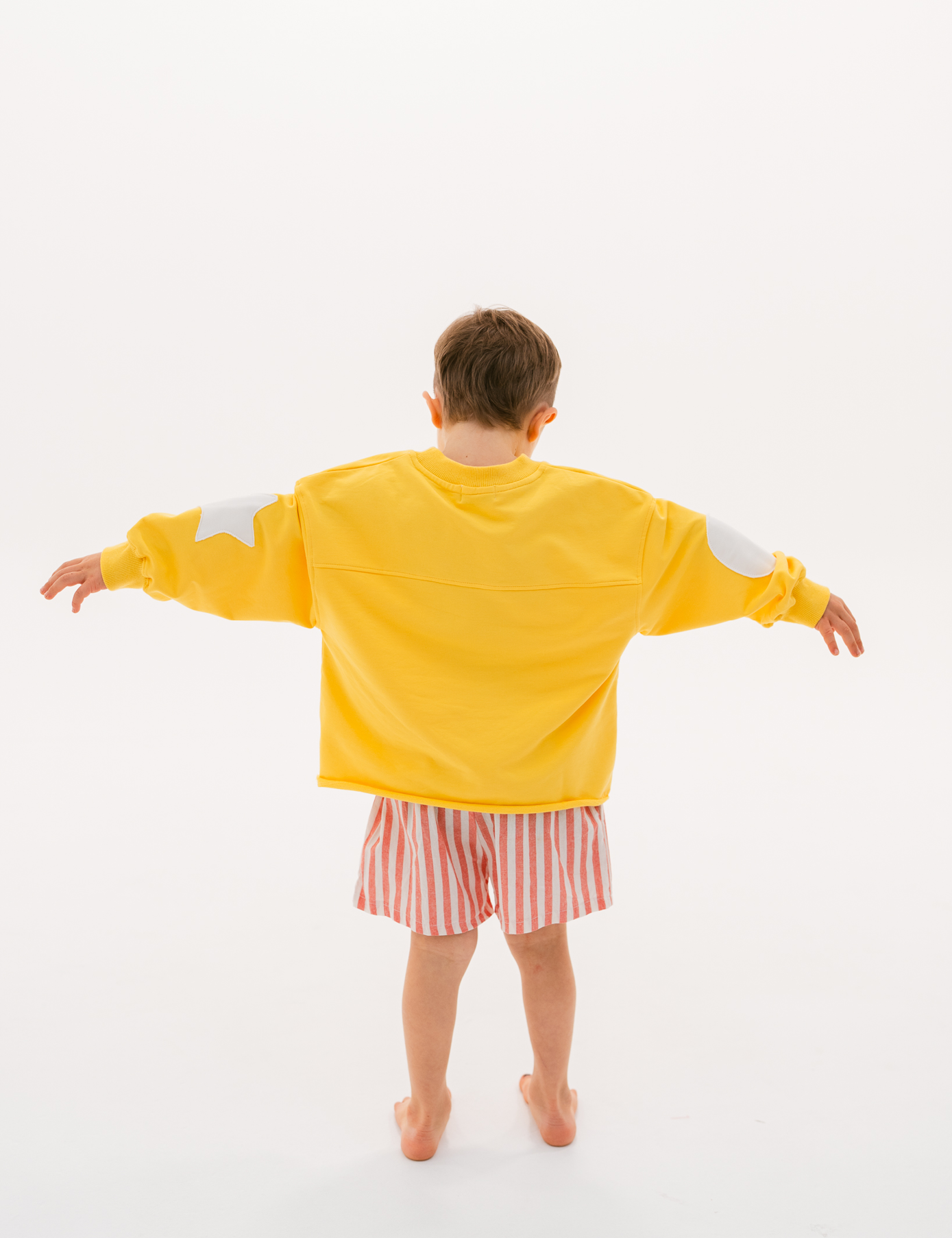 Kids retro sweatshirt in Sunshine yellow with appliqué elbows and frayed hem by Sonny Label
