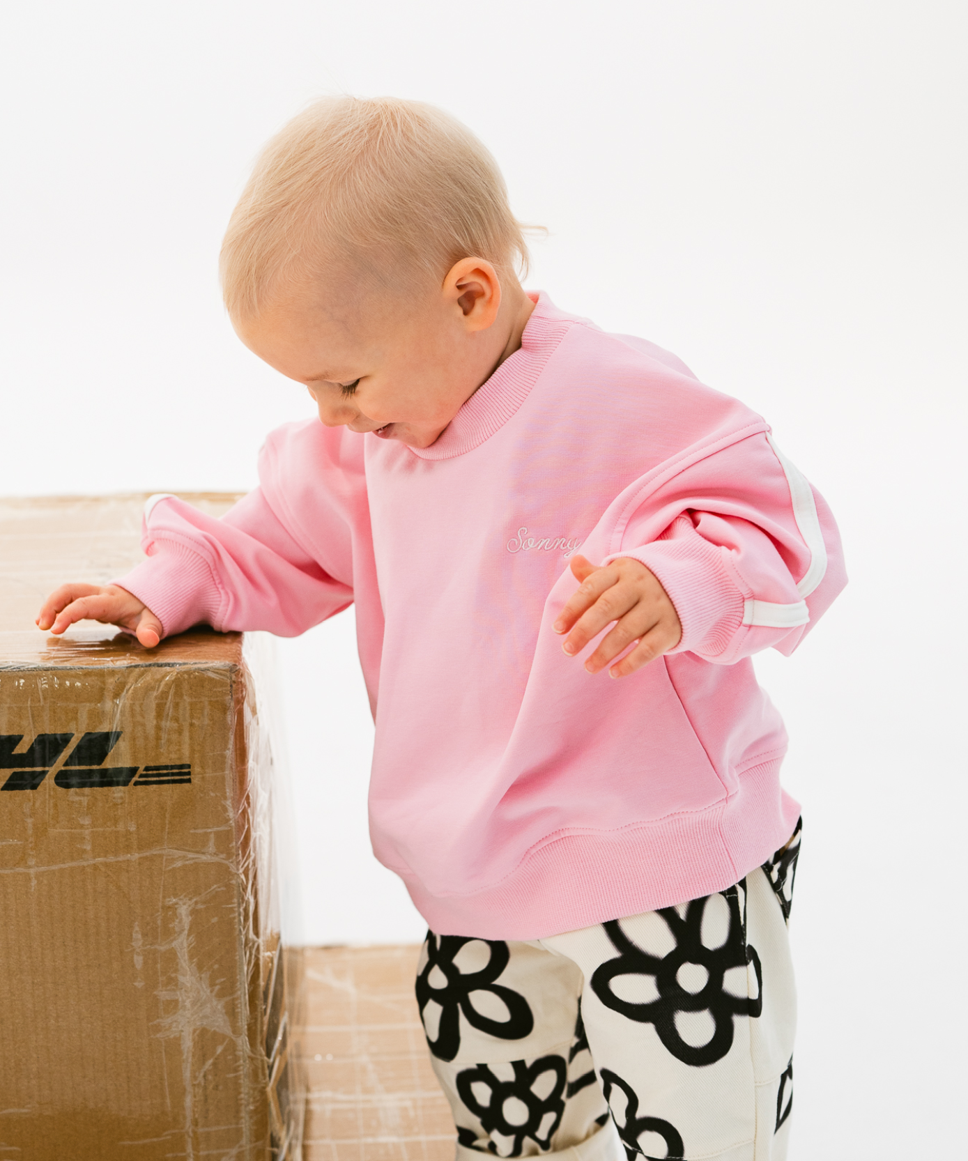 Kids sloppy joe jumper in Flamingo pink with embroidered Sonny logo