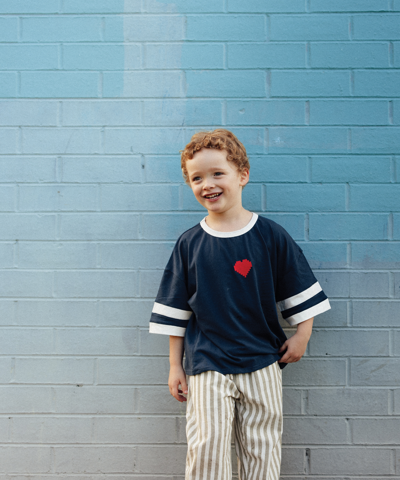 Child in Sonny Label SonnyFaves colourful kids clothing in a lifestyle campaign shot.