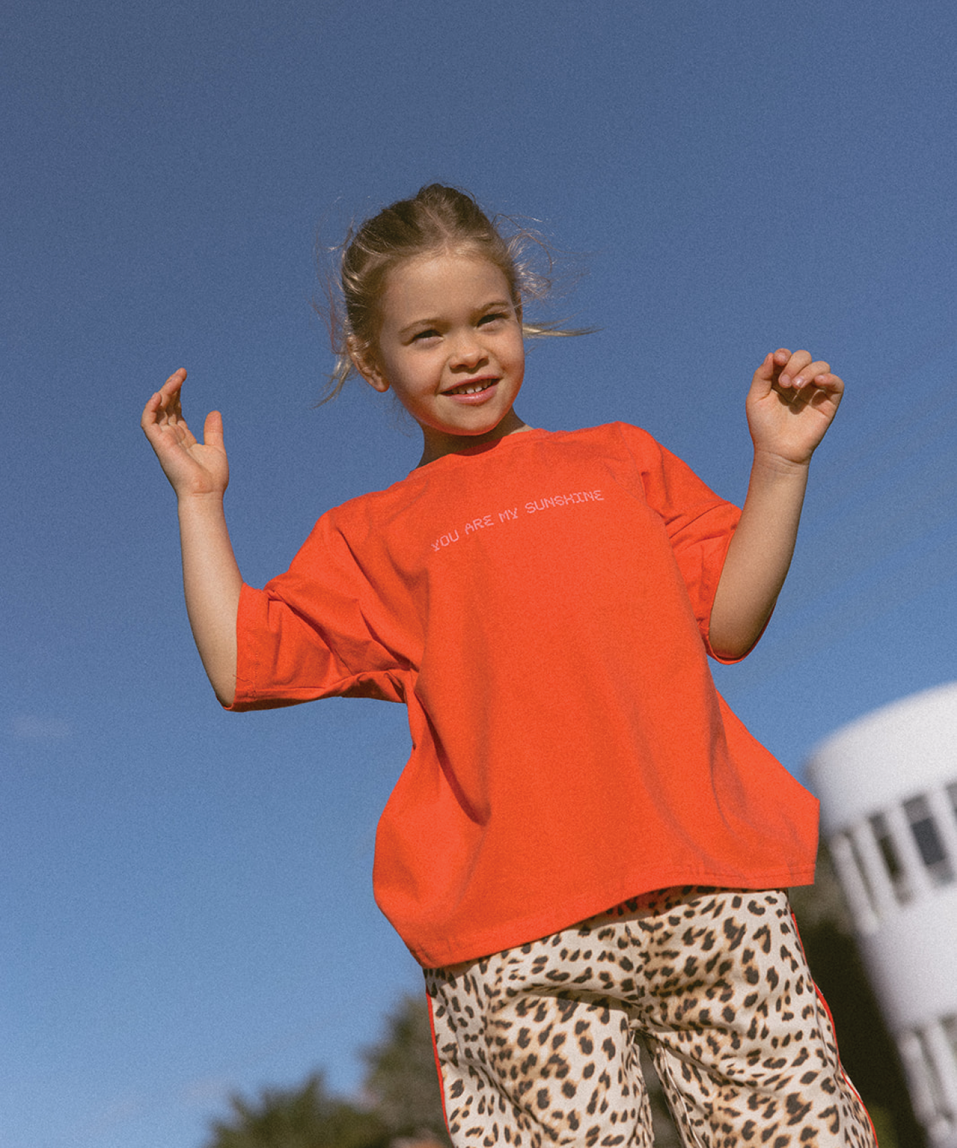 Child wearing a Sonny Label SonnyFaves everyday tee in a lifestyle campaign shot.