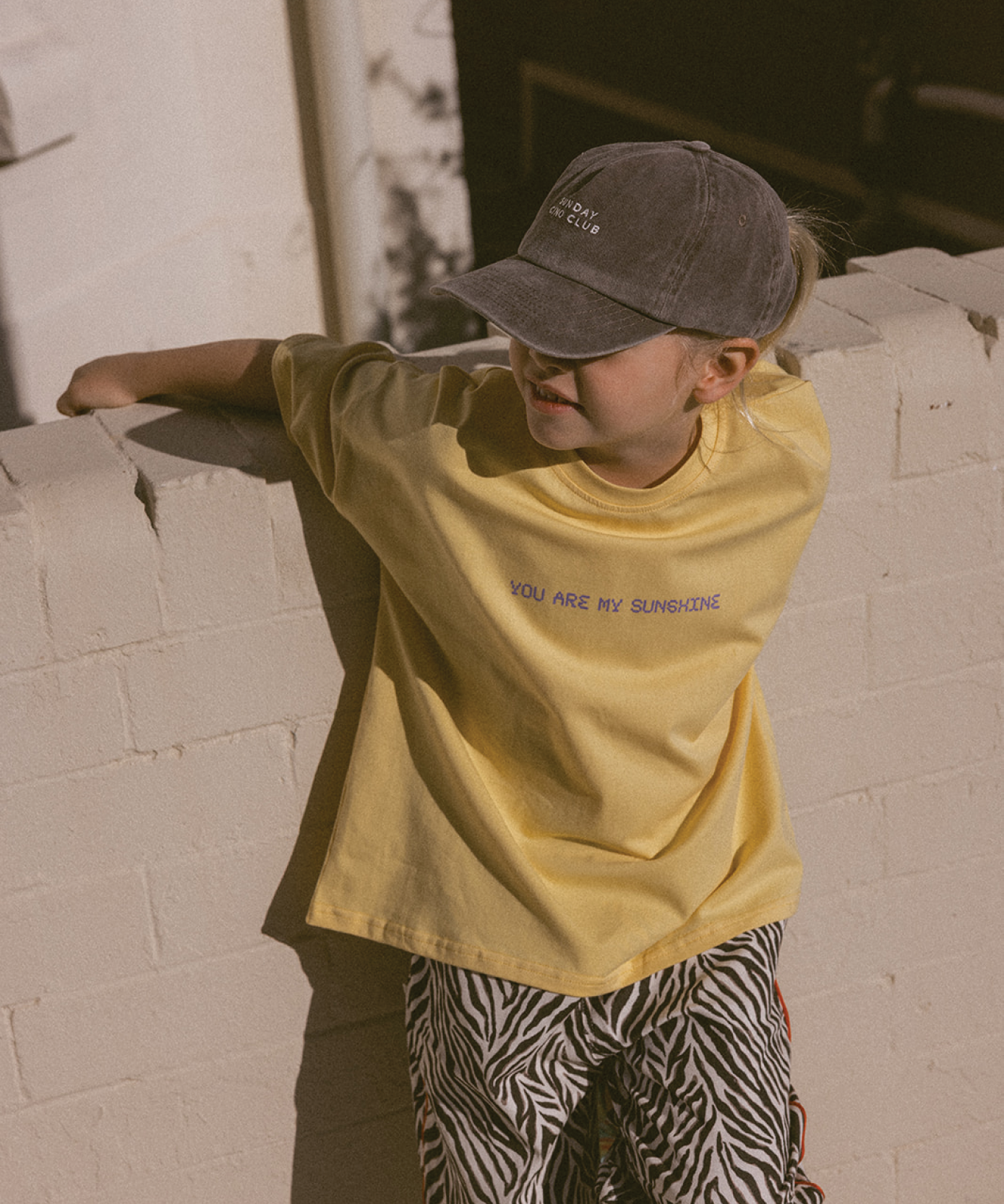 Child wearing a Sonny Label SonnyFaves colourful tee in a lifestyle campaign image.