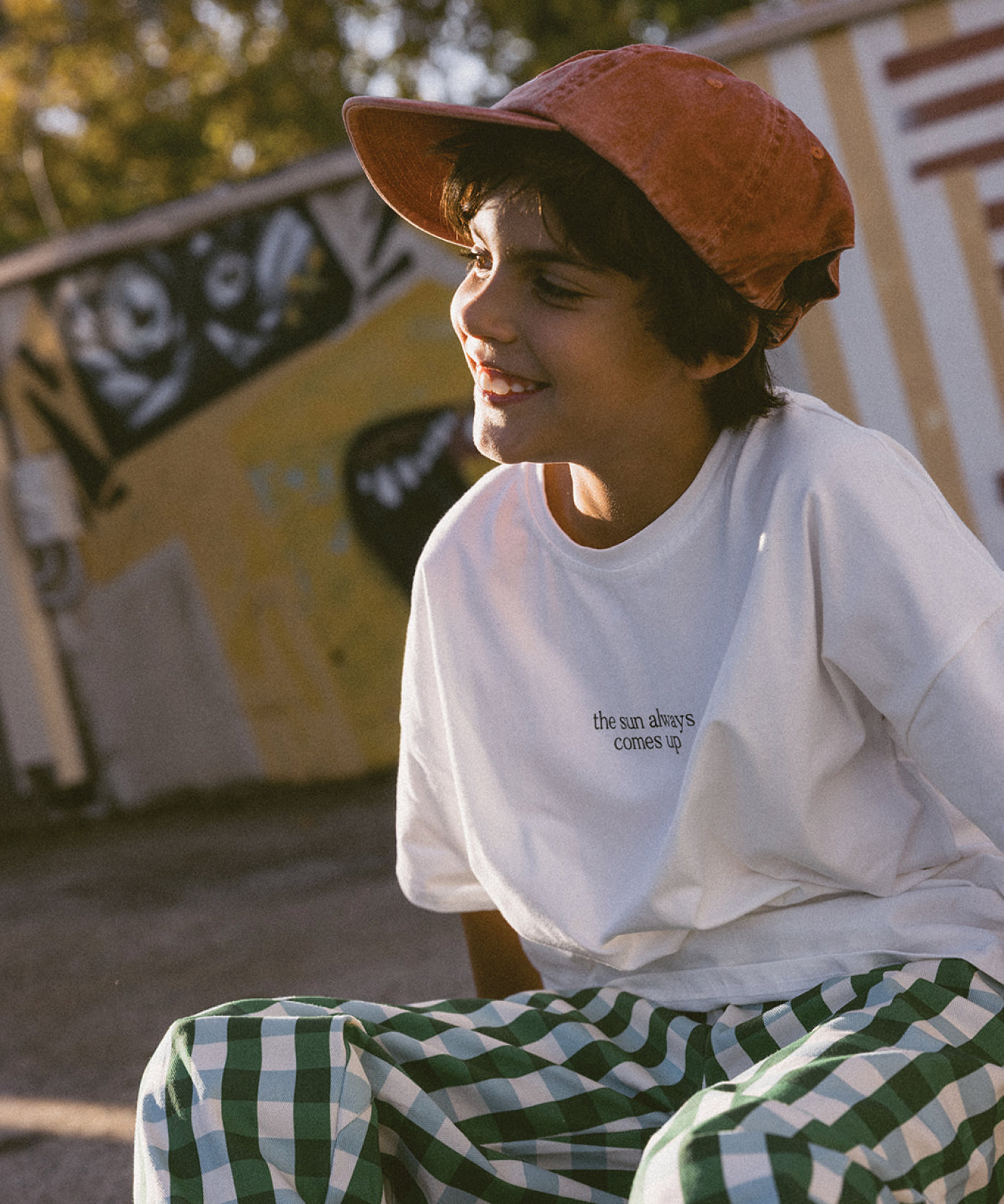 Child wearing a Sonny Label SonnyFaves graphic tee in a bright lifestyle shot.