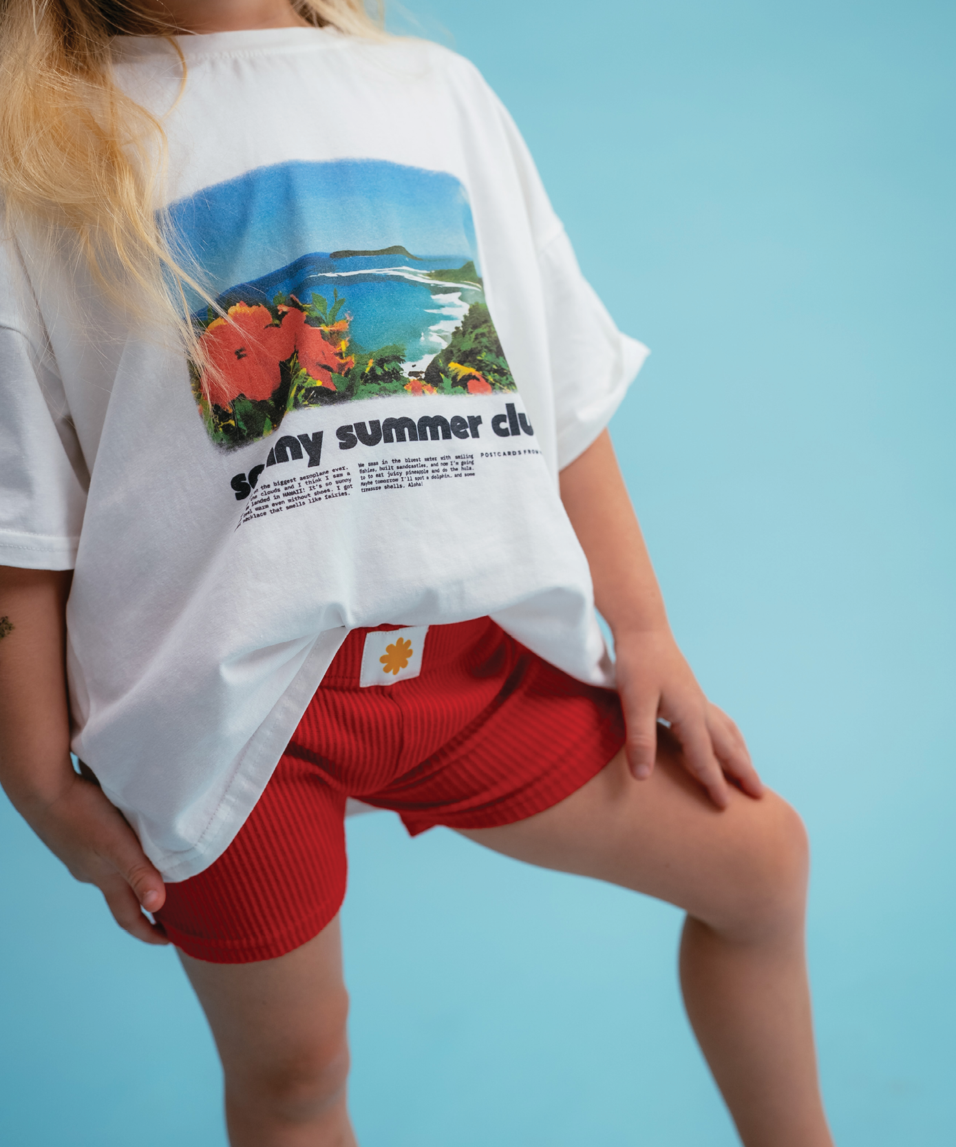 Child wearing Sonny Label Summer25 collection pieces on a sky blue background.
