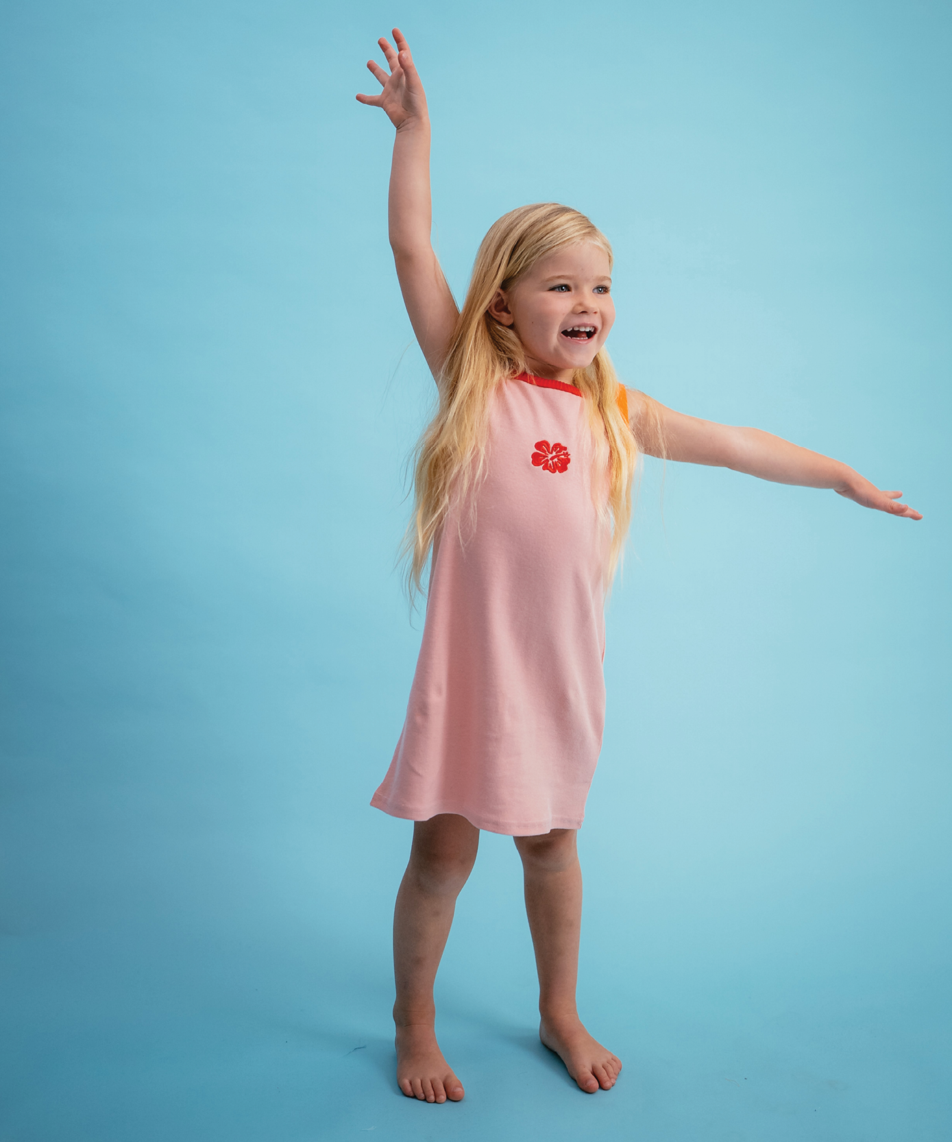 Child wearing Sonny Label Summer25 collection piece on a sky blue background.