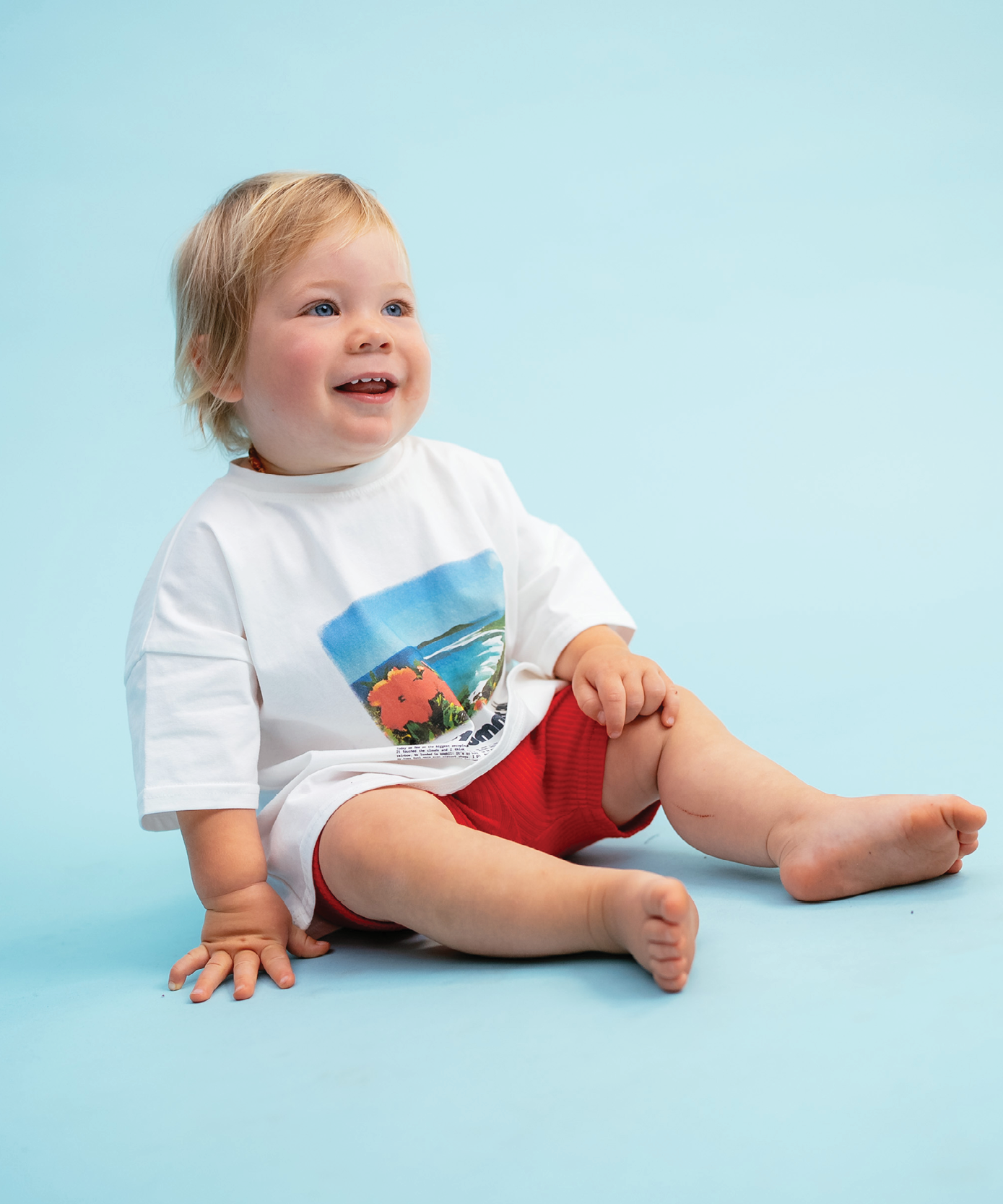 Child in Sonny Label Summer25 summer collection pieces on a sky blue background.