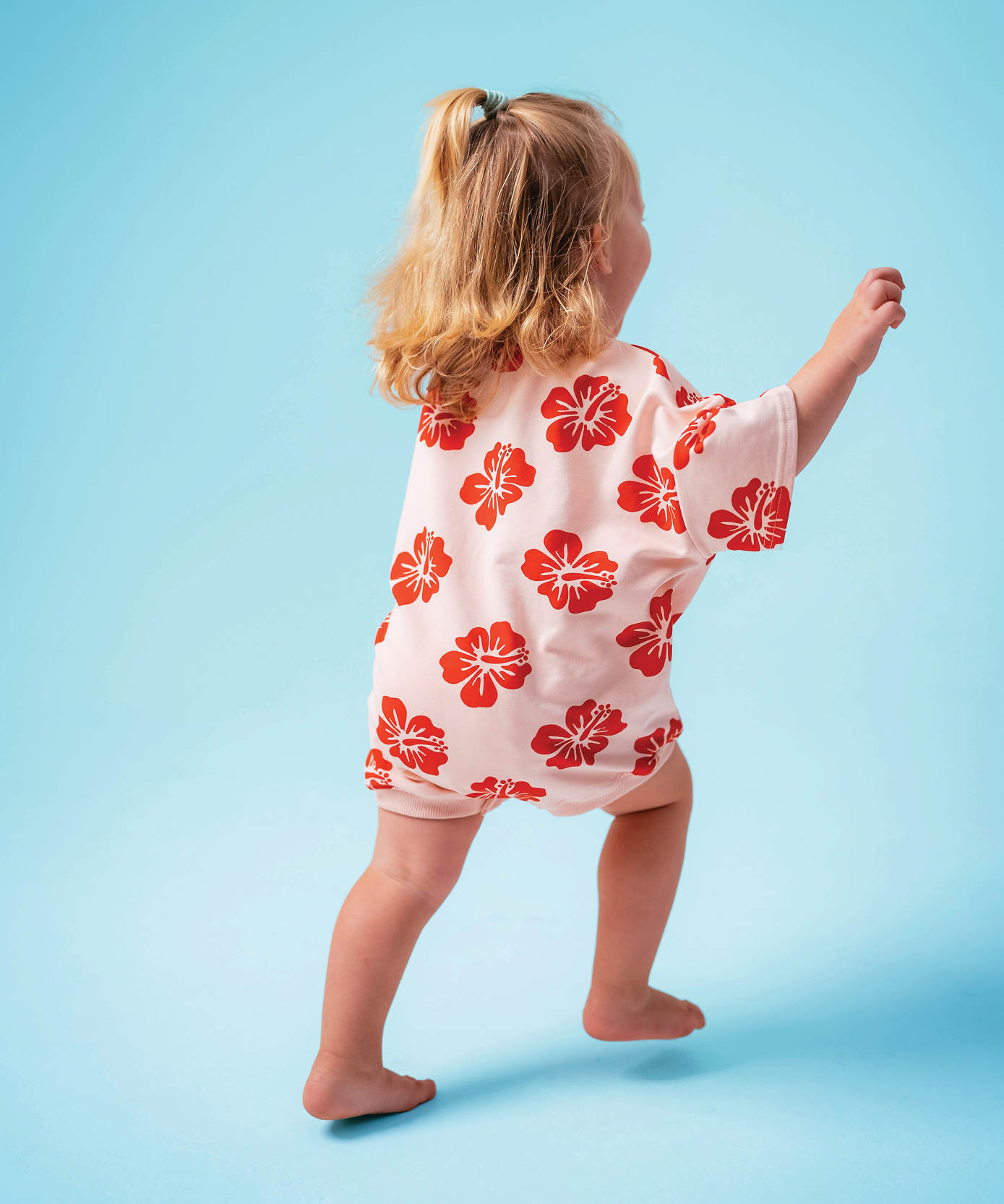 Child wearing Sonny Label Summer25 collection piece on a sky blue background.