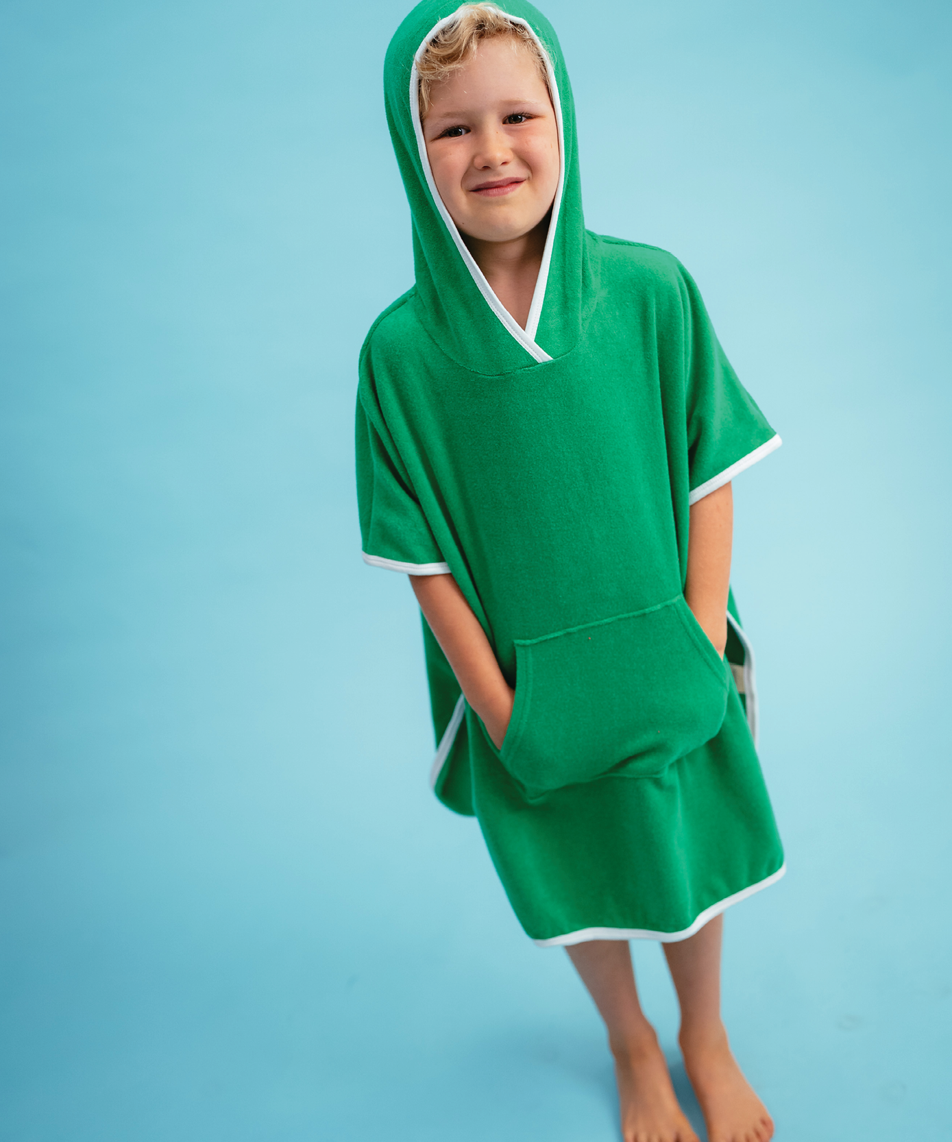 Child in Sonny Label Summer25 summer collection pieces on a sky blue background.