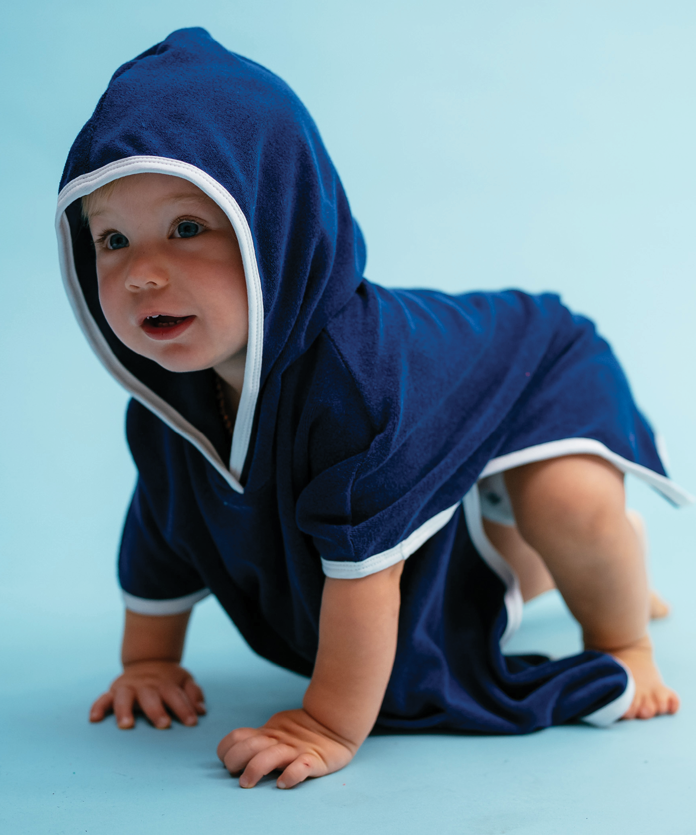 Child wearing Sonny Label Summer25 singlet and knitted shorties on a sky blue background.