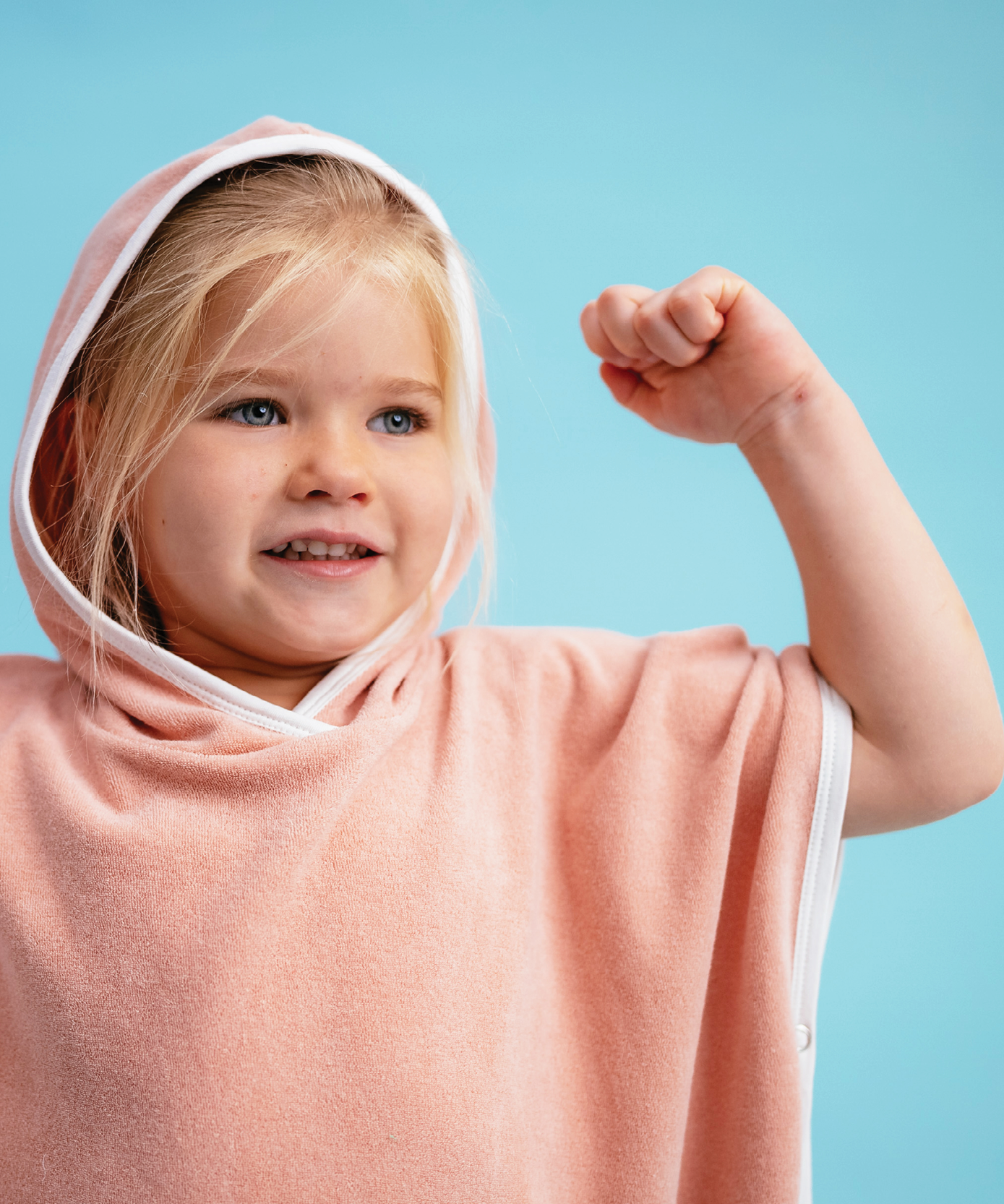 Child in Sonny Label Summer25 summer collection pieces on a vivid sky blue background.