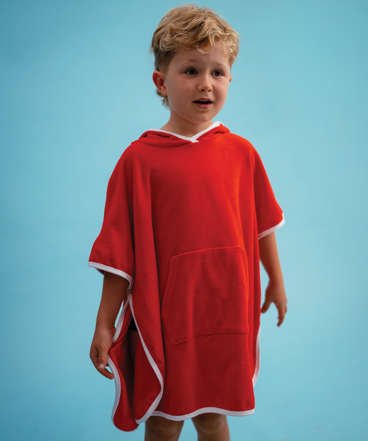 Child wearing Sonny Label Summer25 singlet dress on a vivid sky blue background.