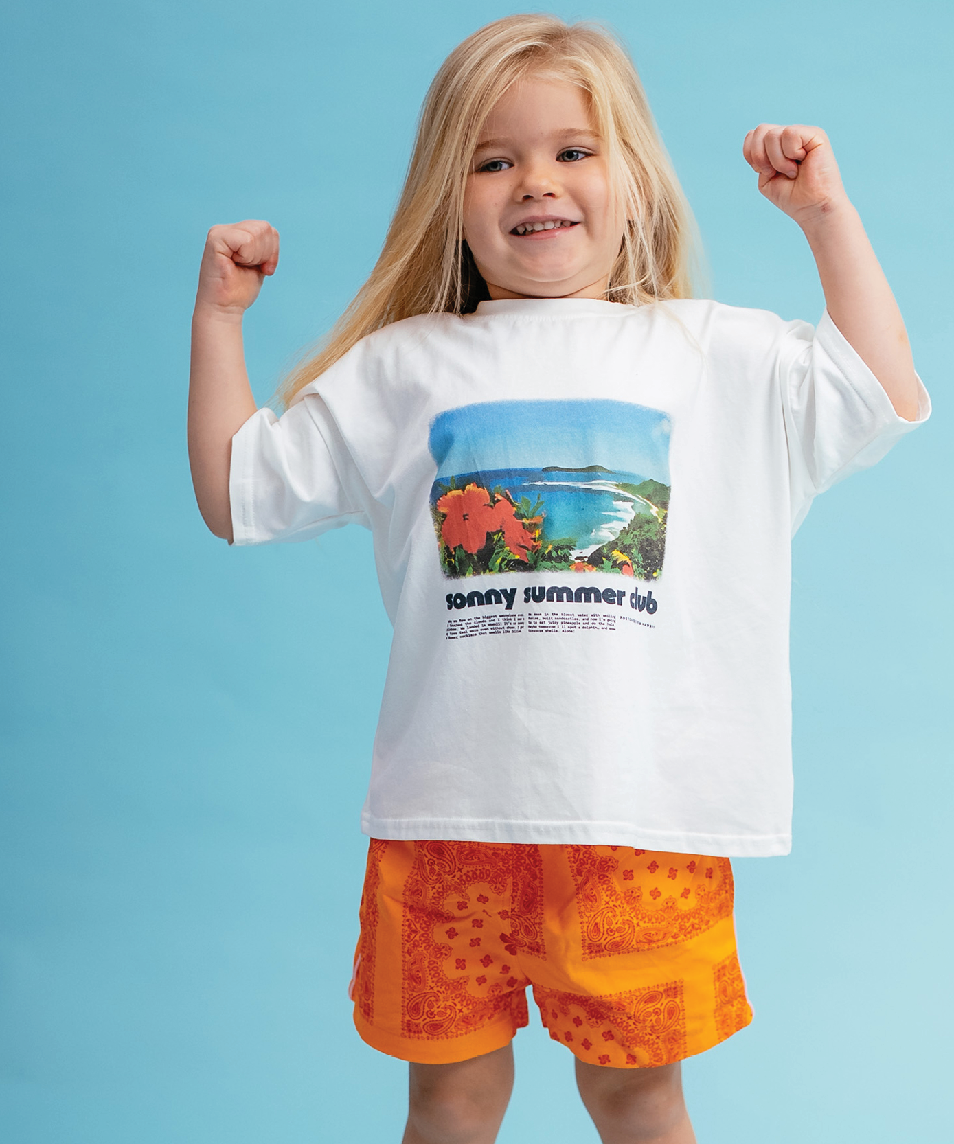 Child in Sonny Label Summer25 collection pieces on a vivid sky blue background.
