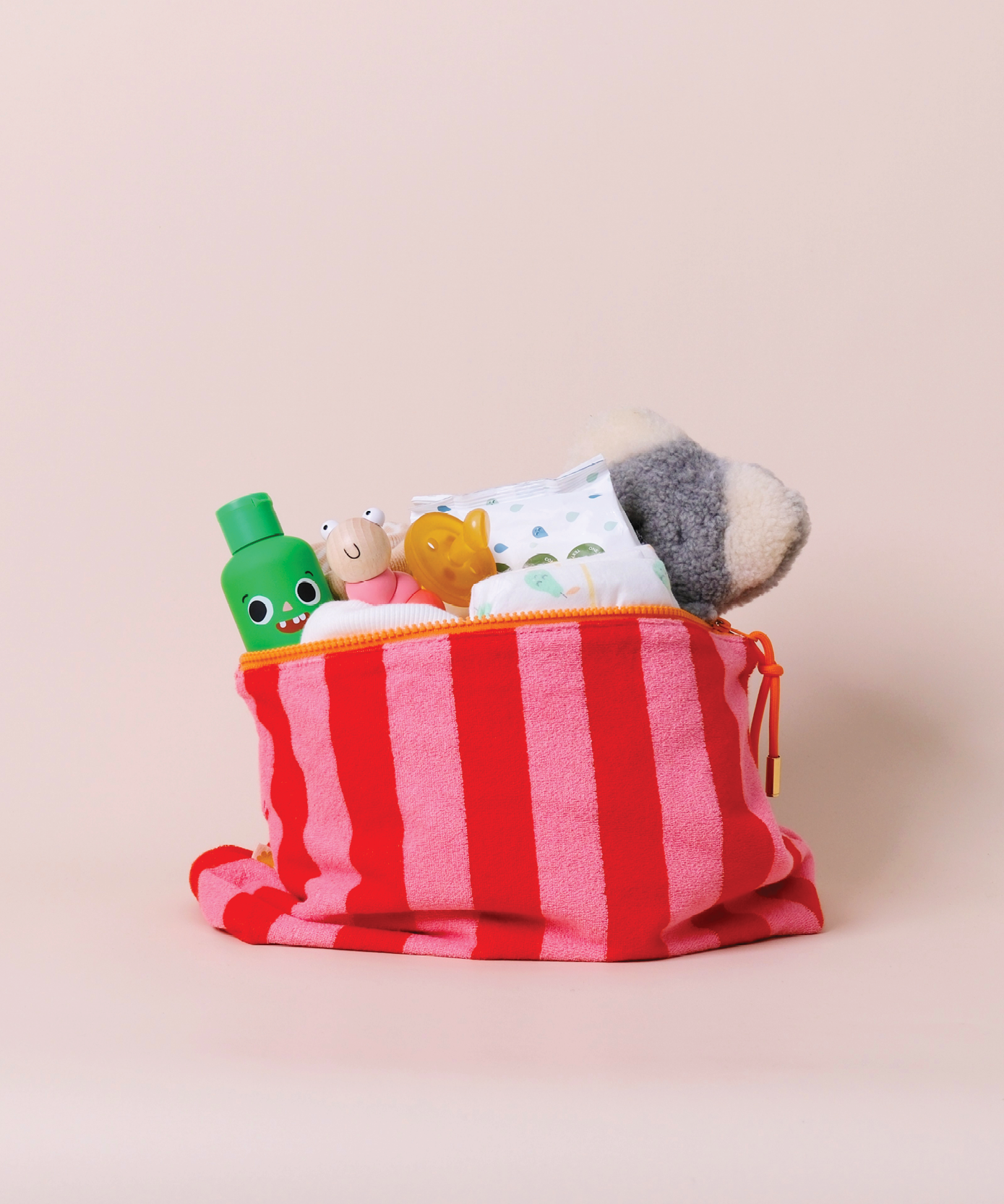 Sonny Label mint stripe terrycloth baby pouch styled on a clean grey background.