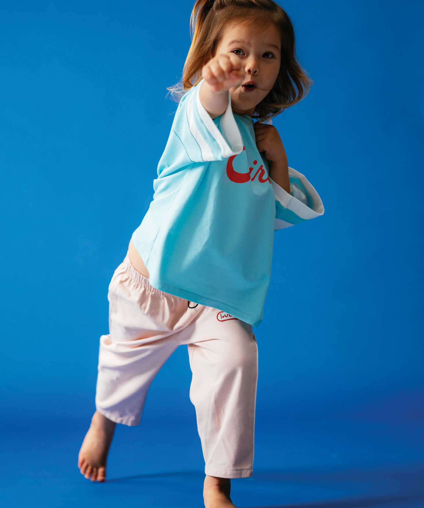 Child wearing Sonny Label Circus26 collection pieces, styled on a deep blue background.
