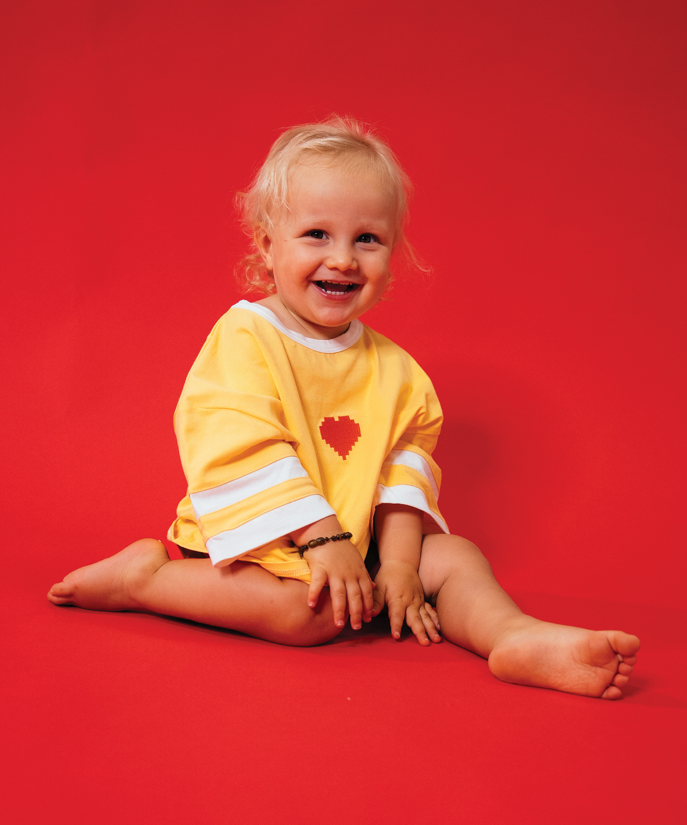 Child in Sonny Label LOVER collection piece on a soft white background.