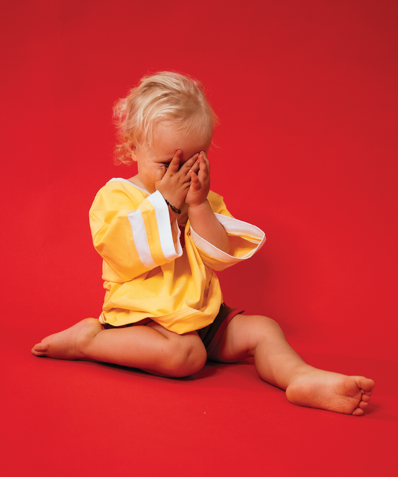 Child wearing Sonny Label LOVER collection — yellow crop tee and matching pieces on a soft white backdrop.