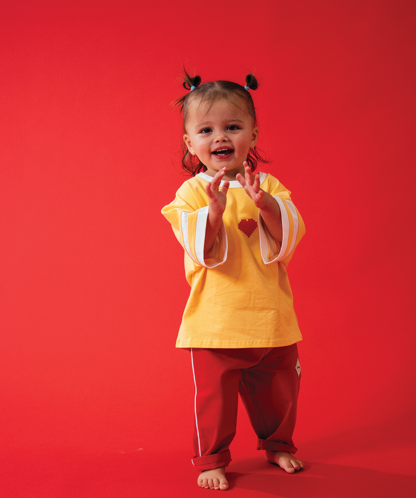 Child in Sonny Label LOVER collection outfit on a light grey studio background.