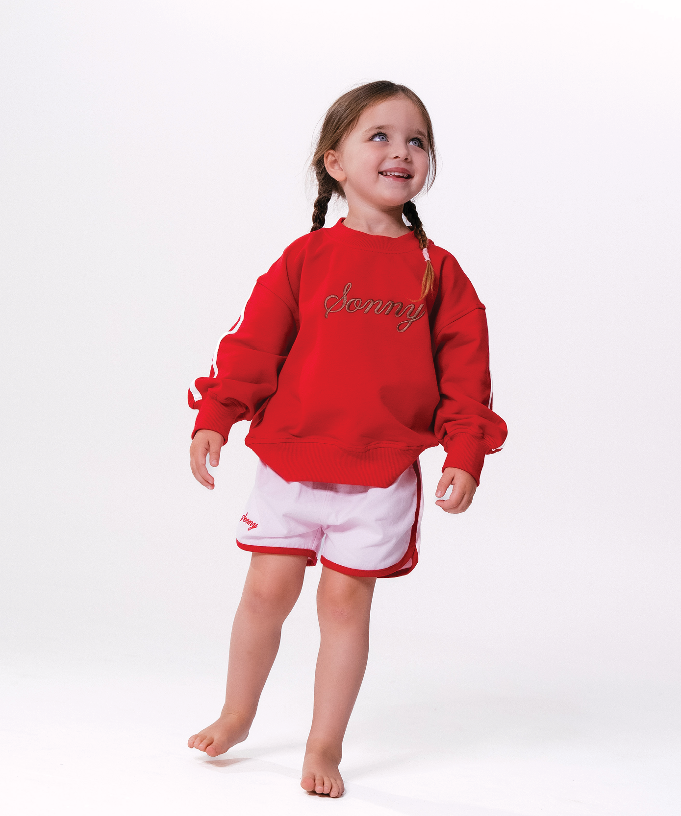 Child in Sonny Label LOVER collection outfit on a soft white studio background.
