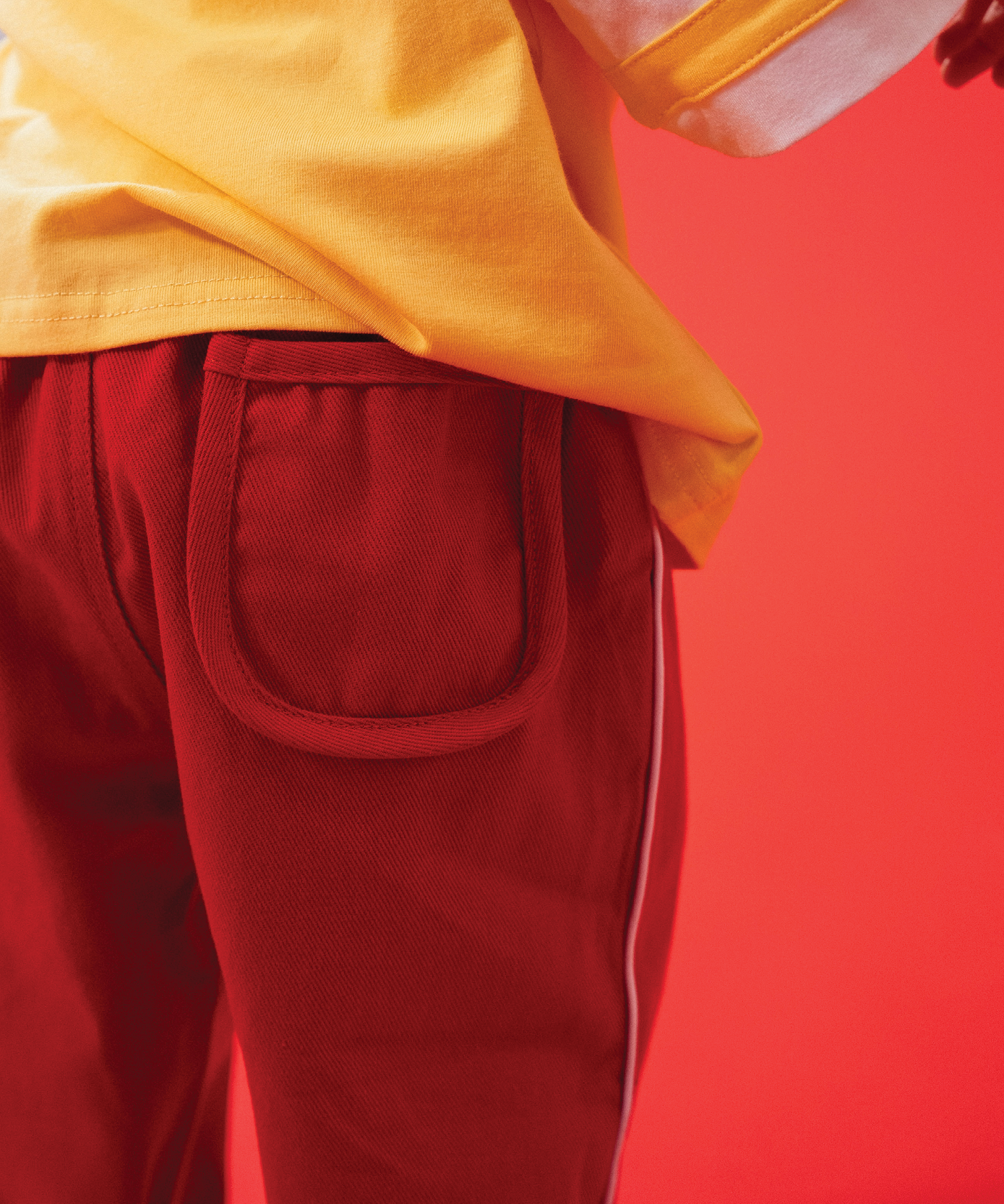 Child wearing Sonny Label LOVER collection pieces with embroidery detail on a soft white background.