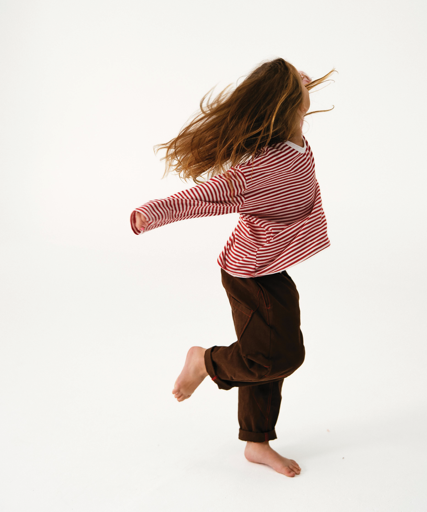 Child in Sonny Label Safari AW25 colourful pieces on a white background.