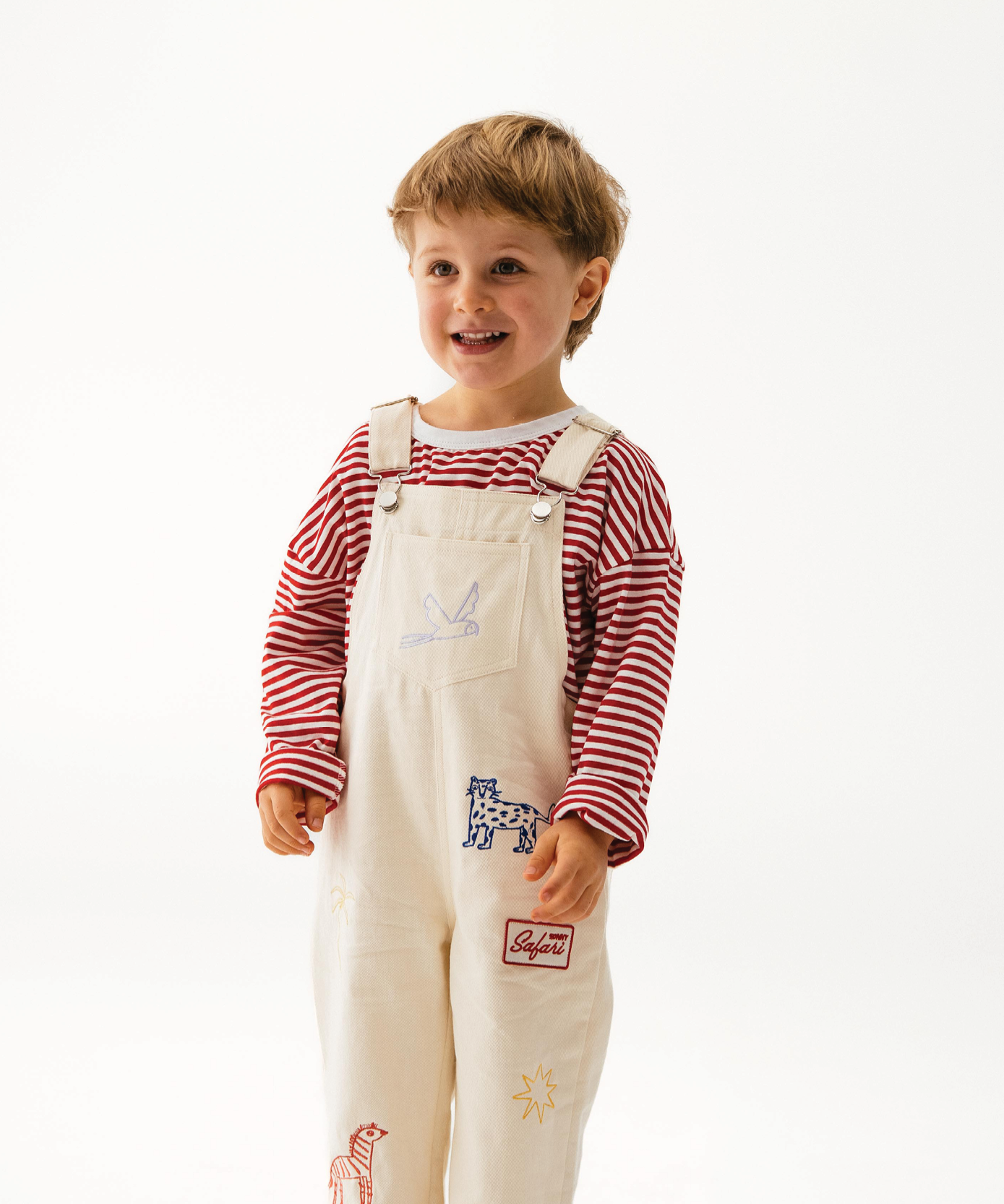 Child in Sonny Label Safari AW25 knit top and safari print pants on a white background.