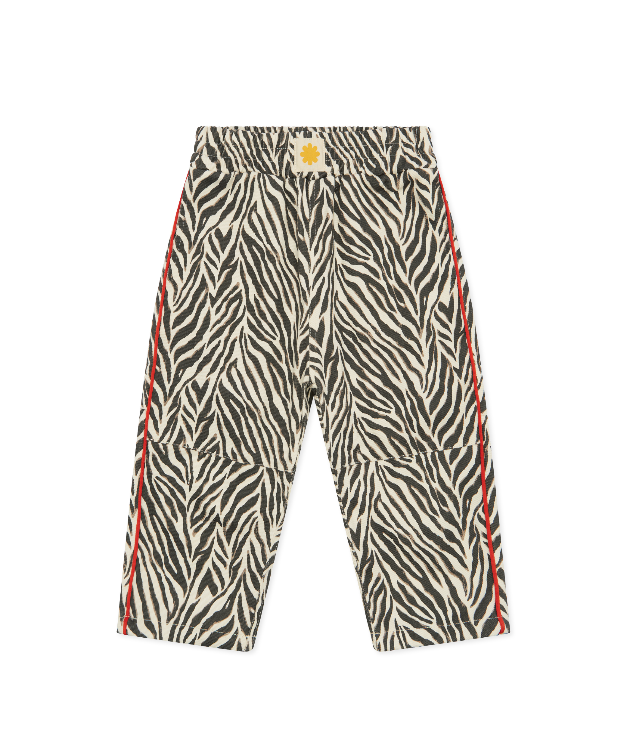 Sonny Label Safari AW25 black and white zebra print wide-leg pocket pants with red stripe and sun badge, flat lay on grey background.