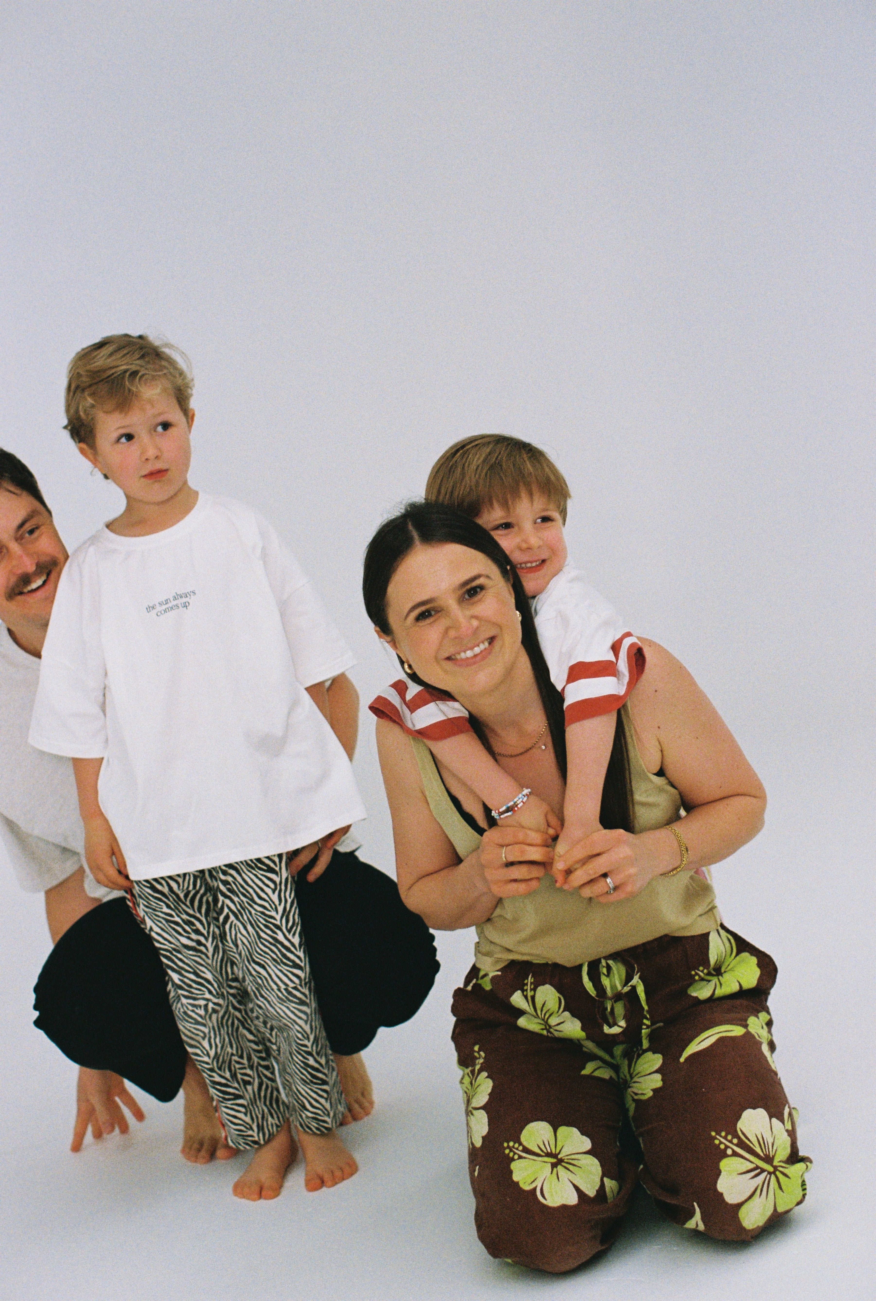 Family of four in a Sonny Label lifestyle film shot — dad, two boys, and mum wearing colourful Sonny Label kids pieces, shot on Kodak Ultramax 400 film.